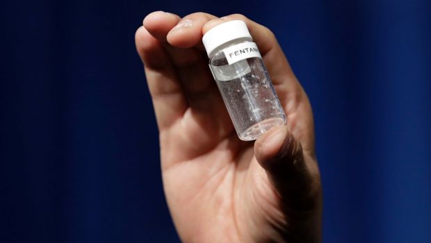 a reporter holds up an example of the amount of fentanyl that